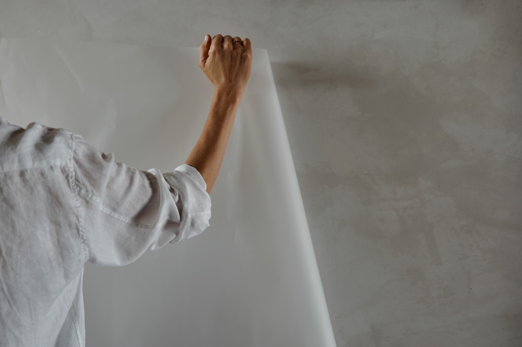 Person holding up tracing paper.