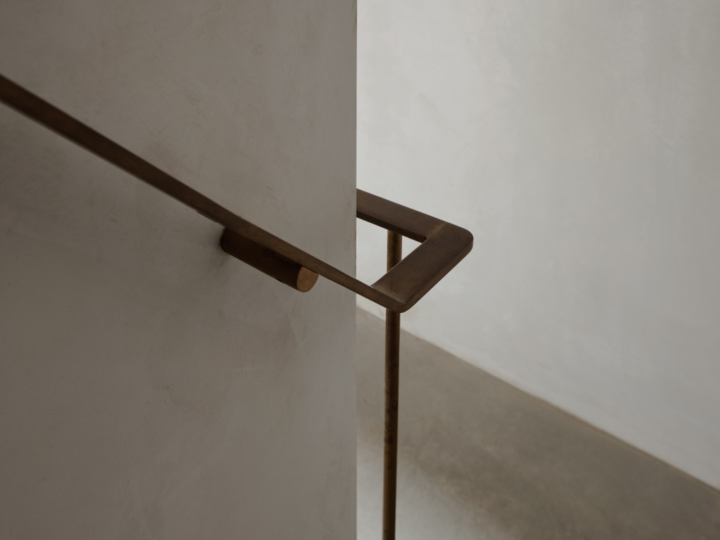 Brass handrail detail of a staircase.