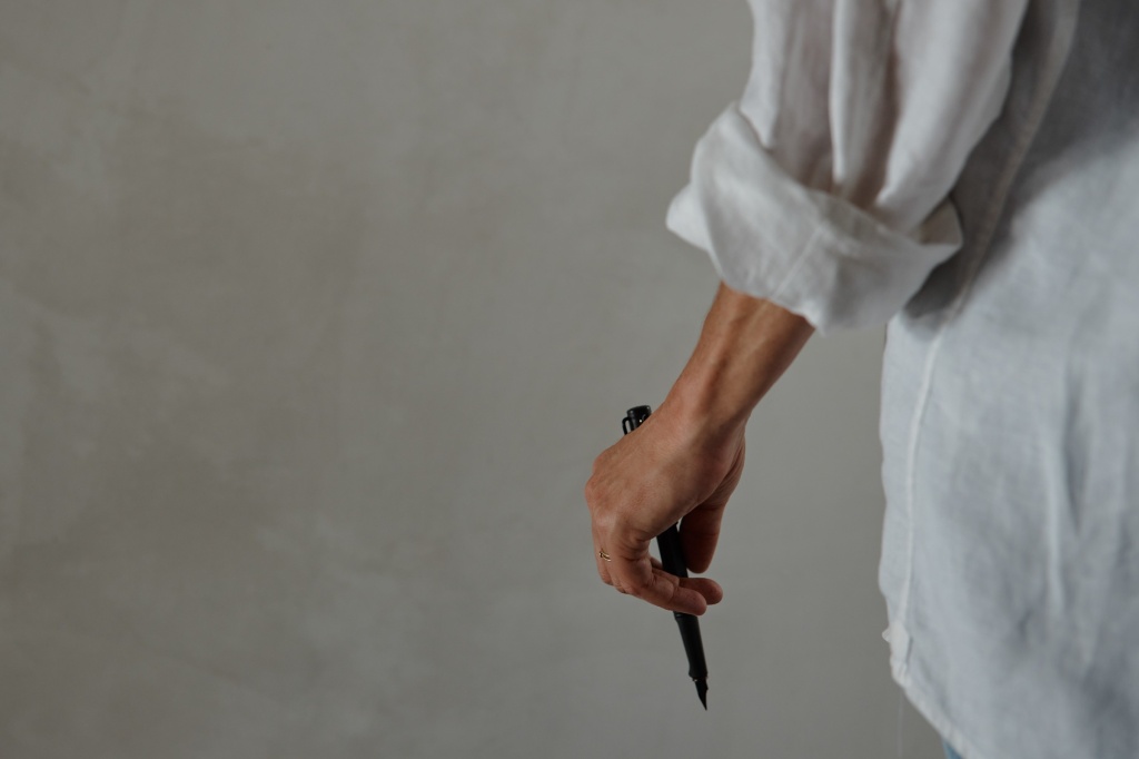 Person holding a Lamy pen.