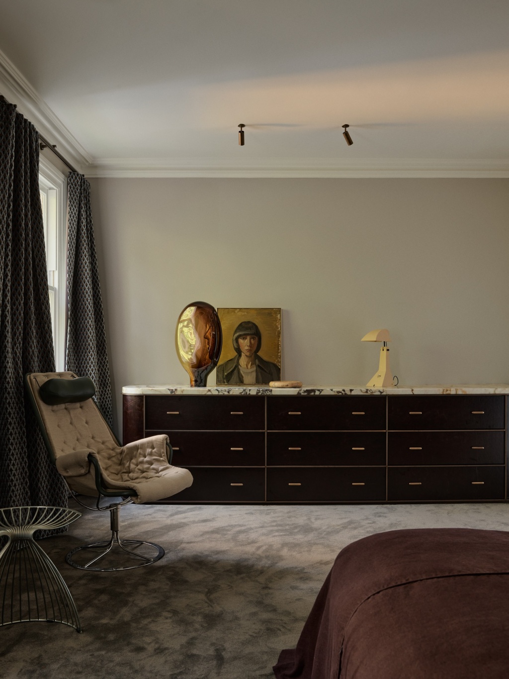 Master bedroom with charcoal carpet and leather fronted console.