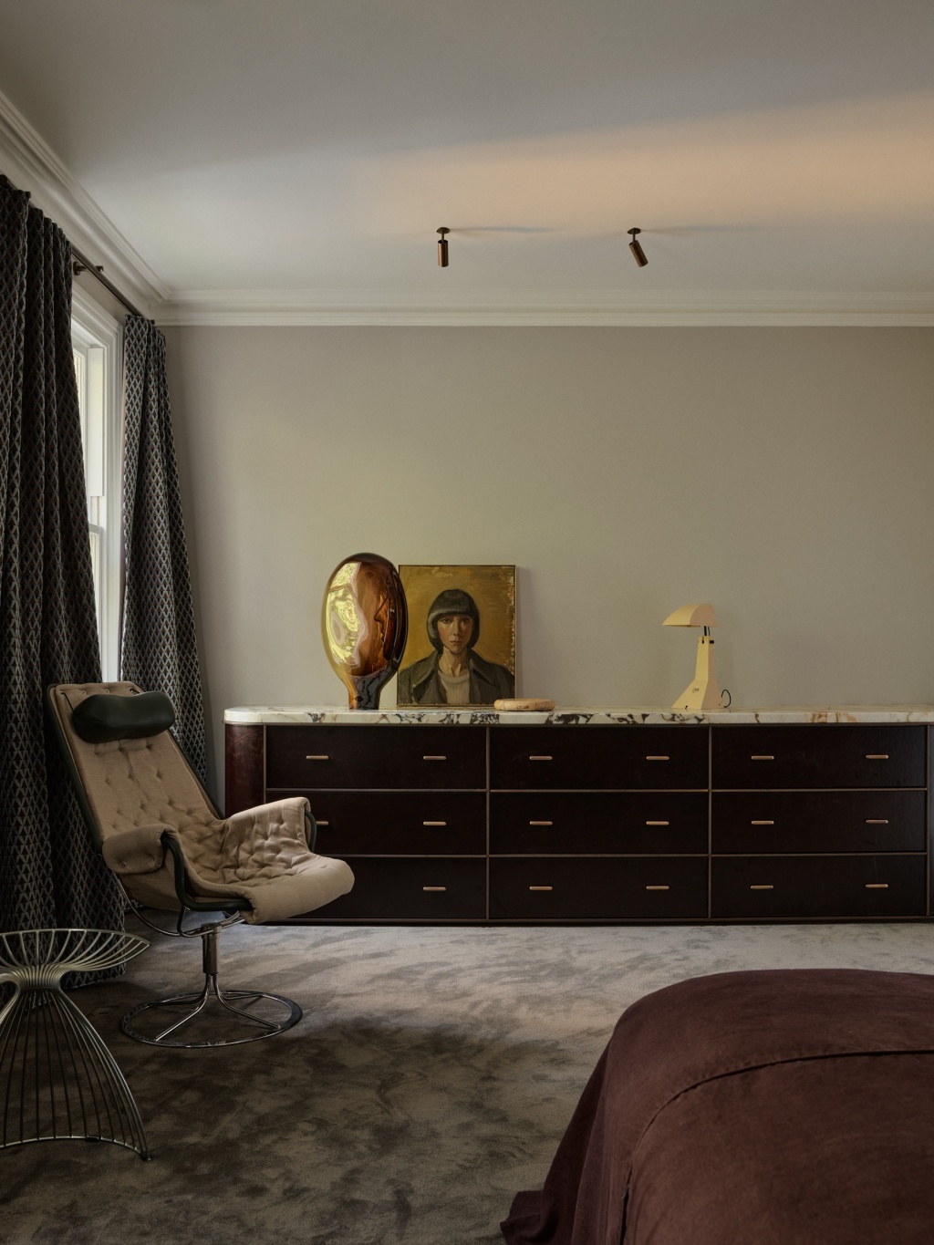Master bedroom with charcoal carpet and leather fronted console.
