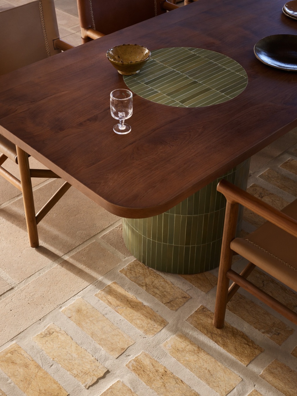 Timber dining table with green tiled base and inlay detail.