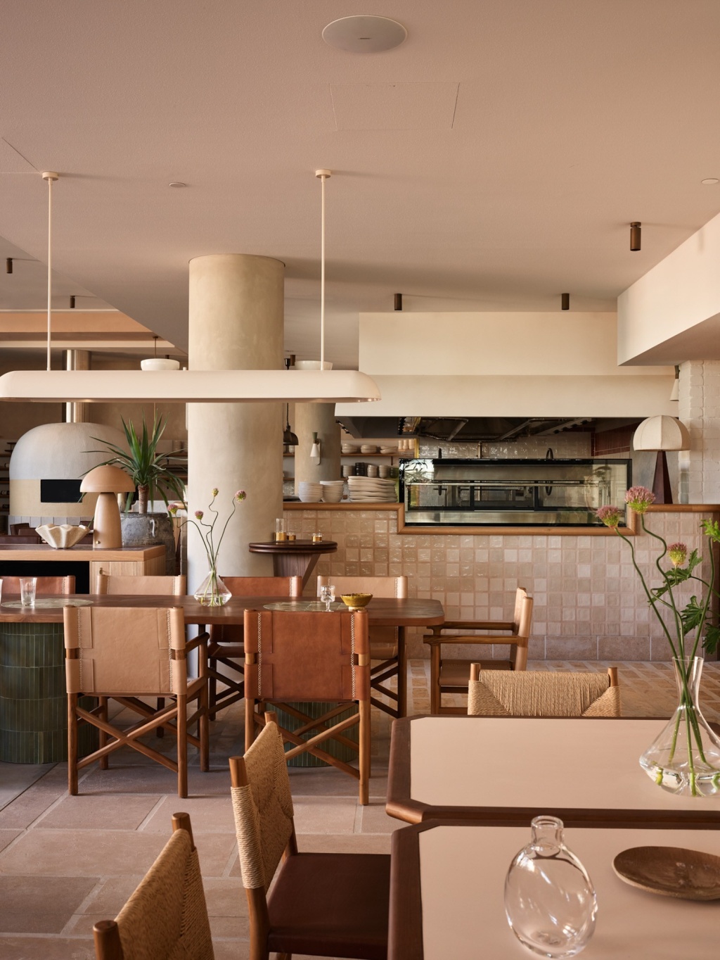 Leather and timber dining chairs and open kitchen.