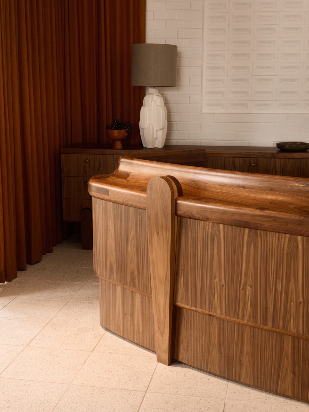 Detail of solid walnut hotel reception desk and console.