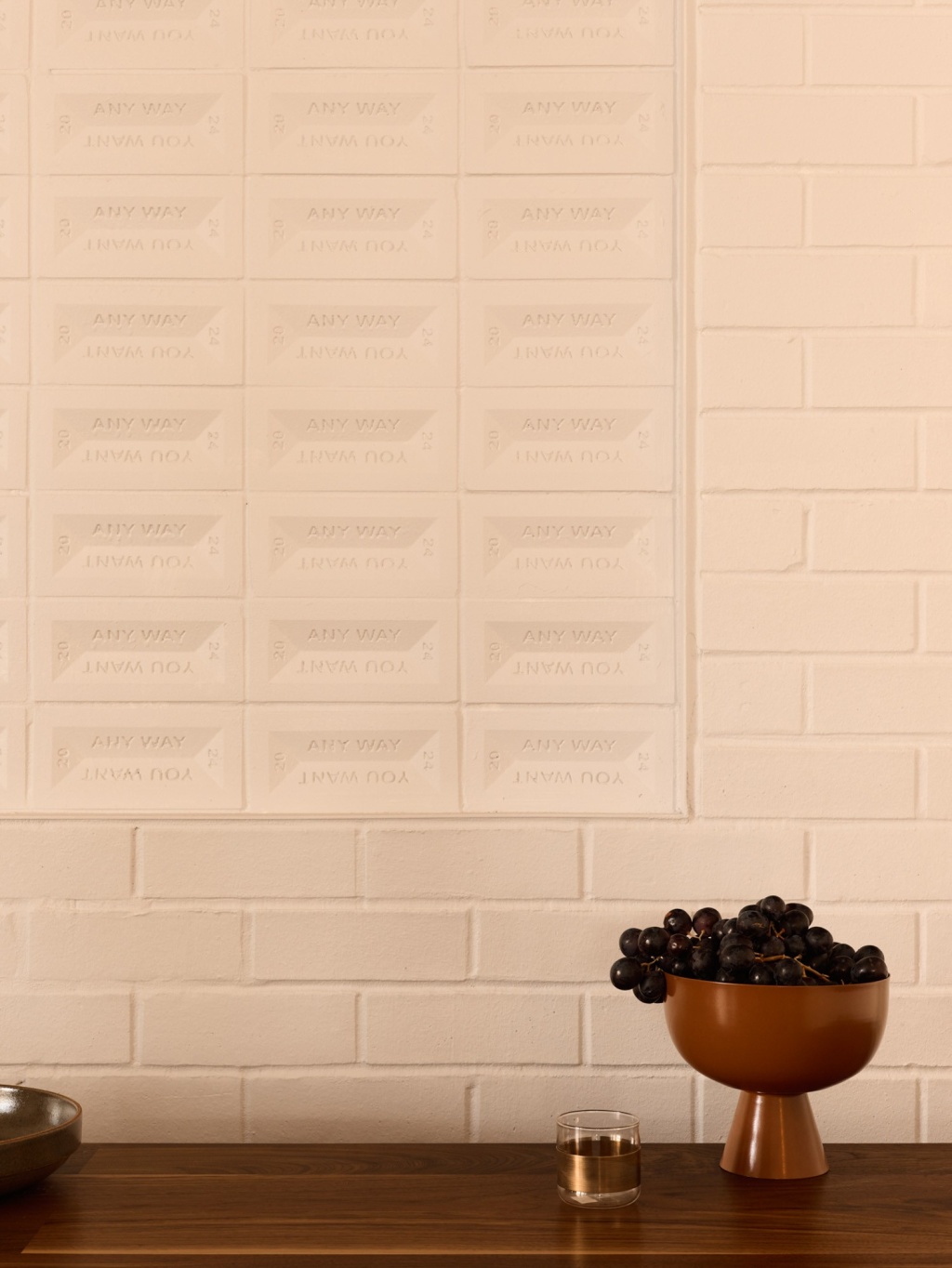 Any Way You Want white brick wall feature.