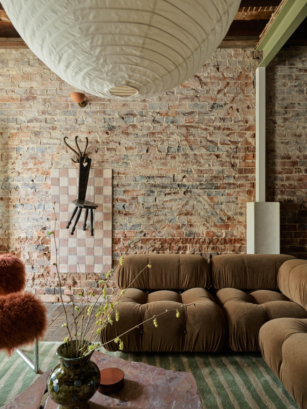 Exposed brick wall and lounge room in The A&CO. Workshop.