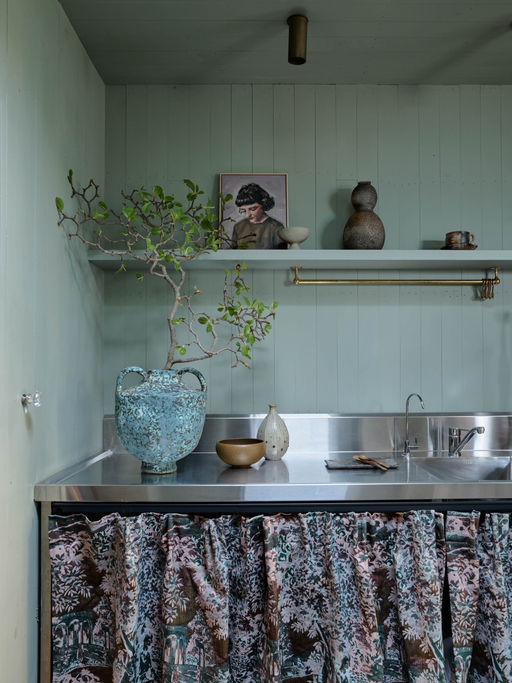 Sage green and stainless steel kitchenette of The A&CO. Workshop.